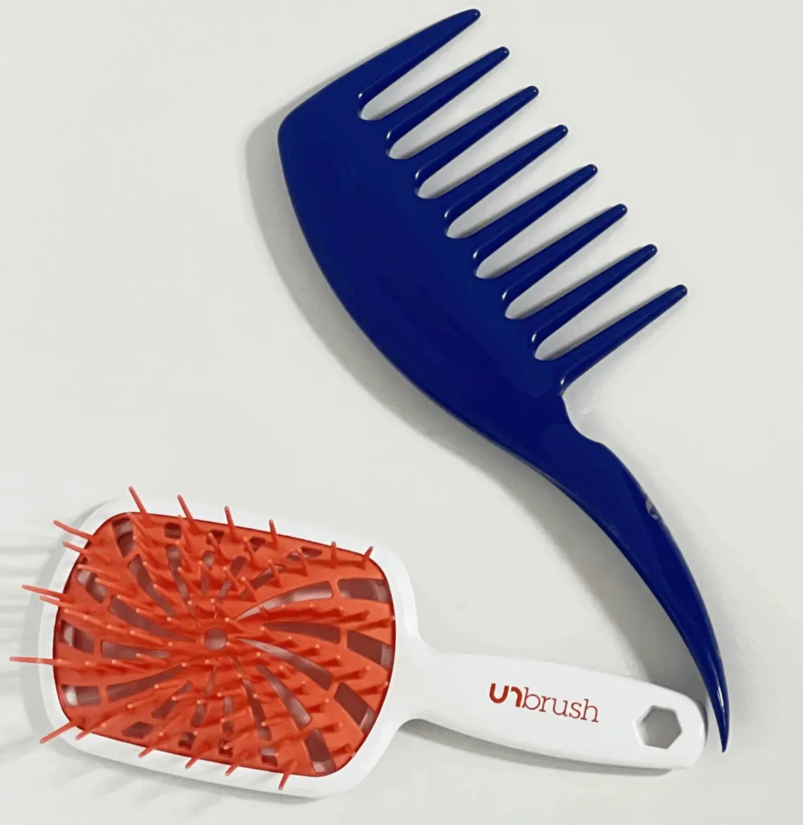 tools for wash and go. a blue kazmaleje detangling comb and an orange and white FHI un brush plus detangling brush
