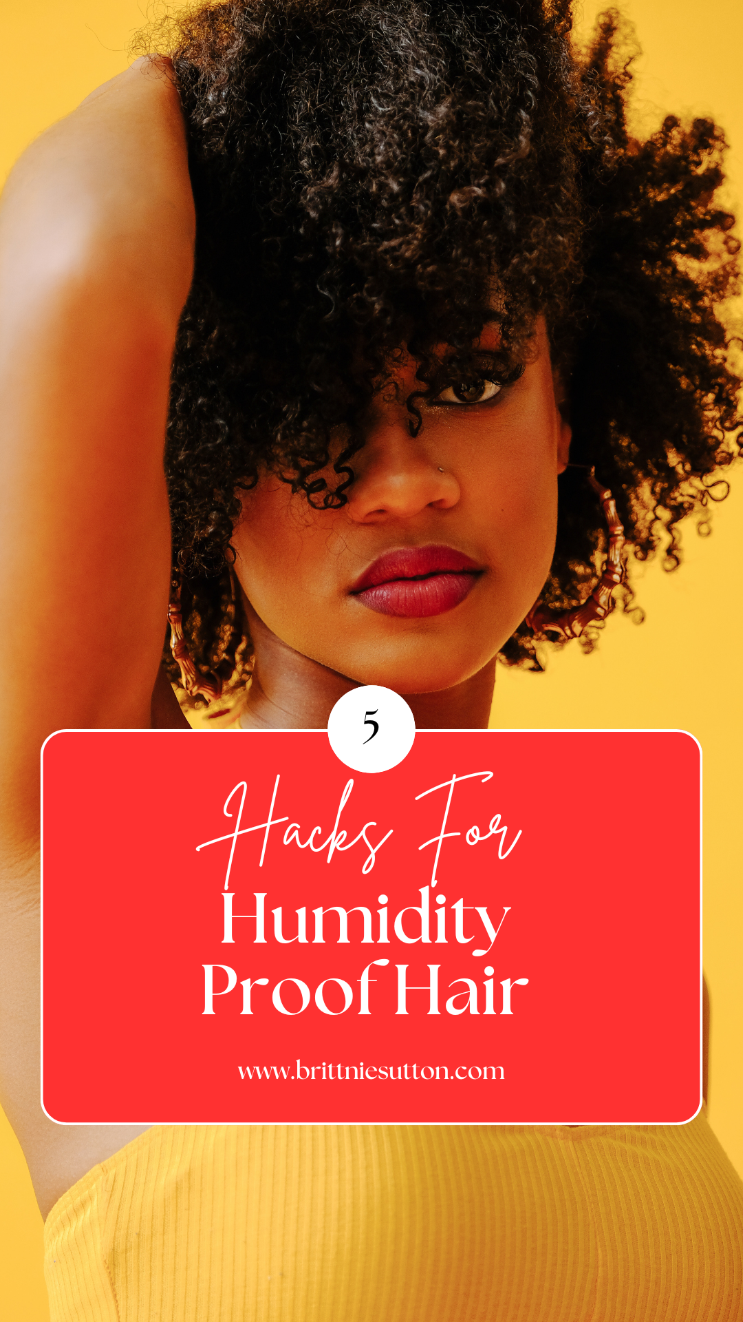 Black woman with naturally curly hair wearing a yellow shirt with a yellow background posing with her hand touching her hair. with text about humidity proof hair for summer weather.