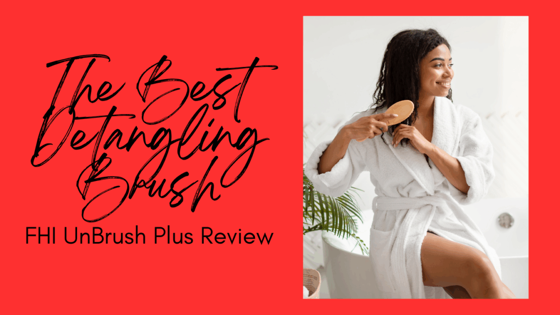 A black woman in a bath robe detangling her naturally curly hair with a detangling hair brush sitting on the edge of a bathtub