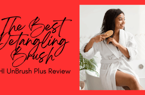 A black woman in a bath robe detangling her naturally curly hair with a detangling hair brush sitting on the edge of a bathtub