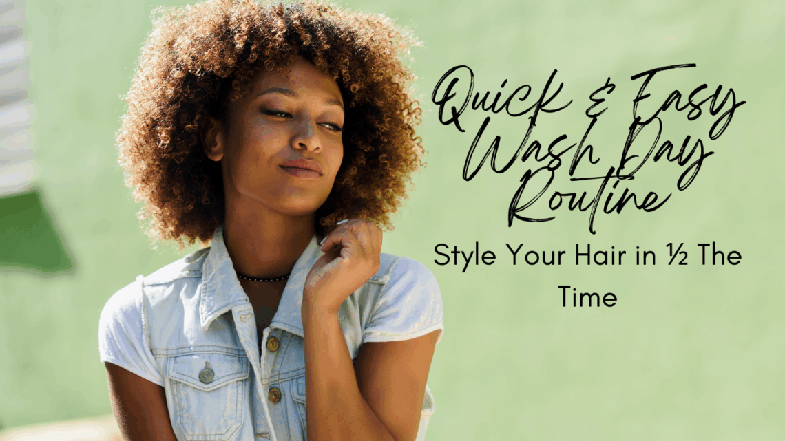woman with a brown curly afro smiling and touching her hair against a green back ground.
