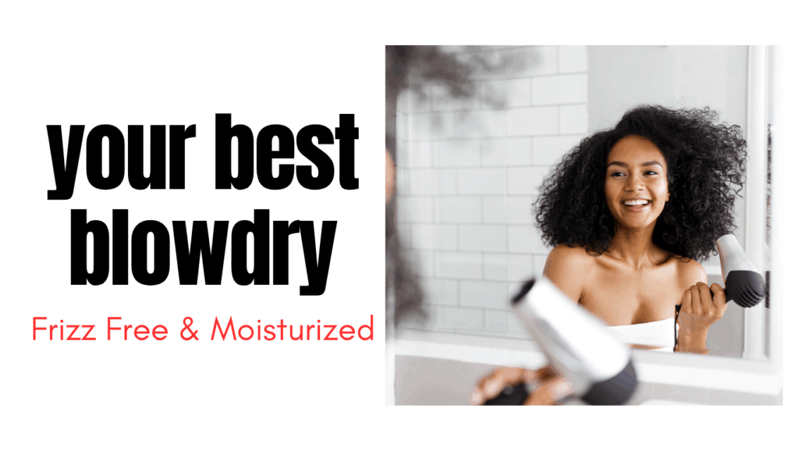 black woman drying her natural hair standing in front of a mirror holding a blow dryer in her hands while smiling