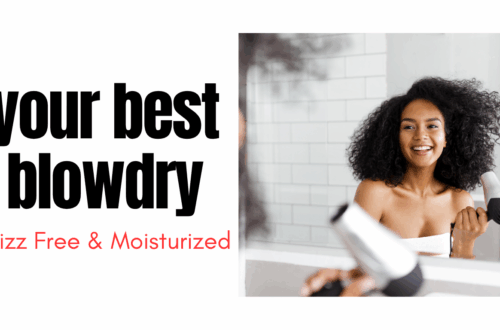 black woman drying her natural hair standing in front of a mirror holding a blow dryer in her hands while smiling
